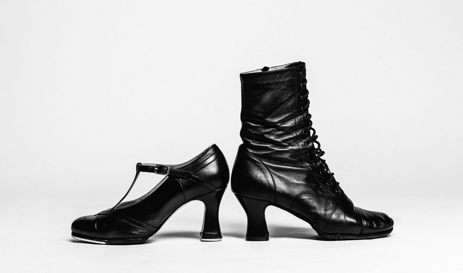 A vintage T-strap character heel beside a lace-up leather dance boot