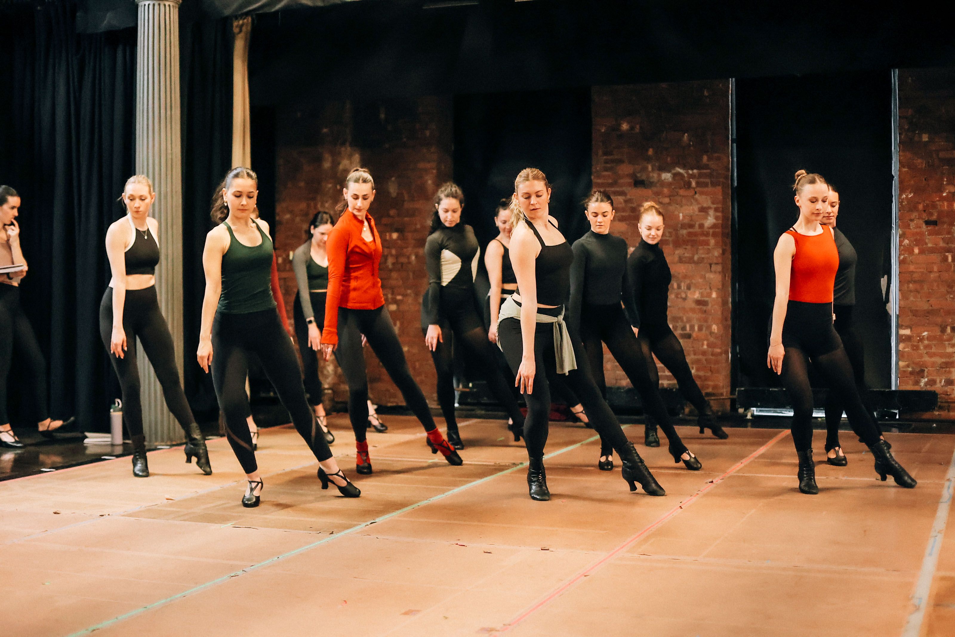 Precision Dance Collective full ensemble rehearsing synchronized choreography in formation