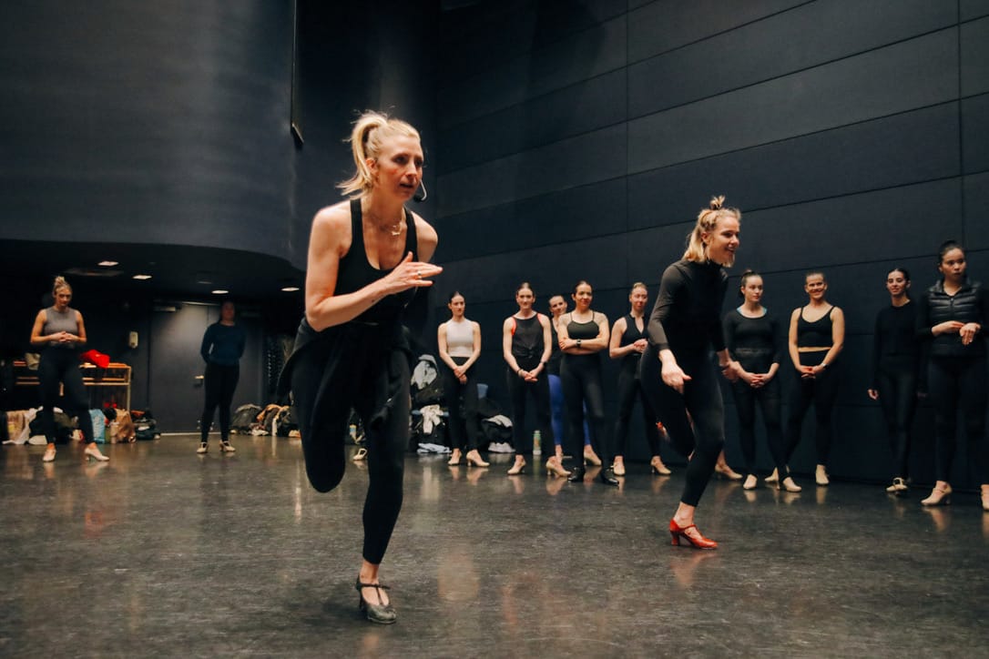 Founder demonstrating movement while dancers observe